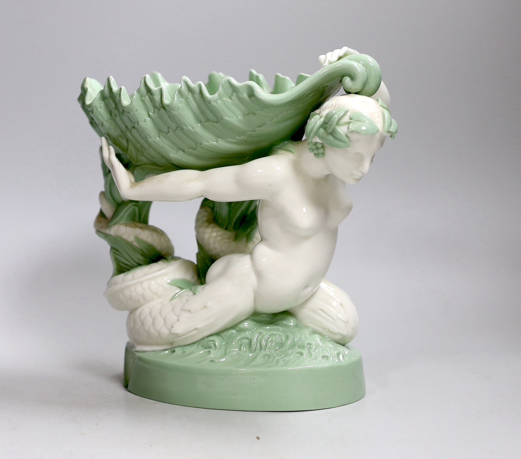 A 19th century Minton celadon glazed figure of a mermaid with a shell on her back, 21cm tall